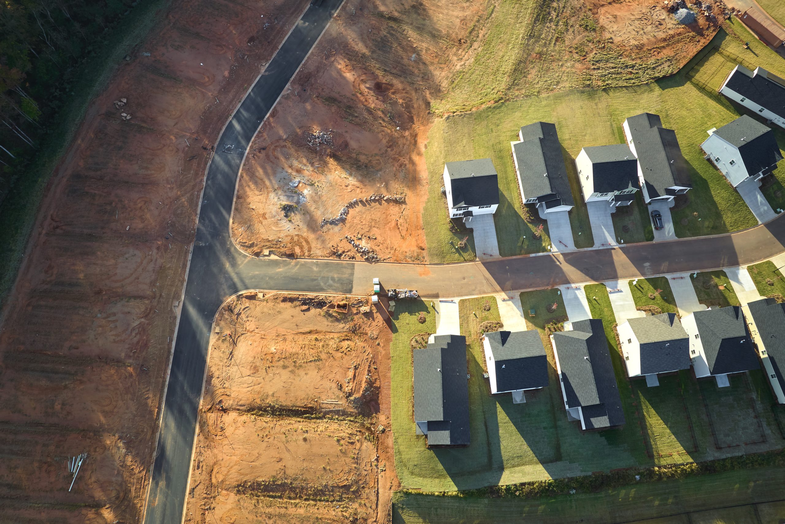 Aerial view of land development growth in Edmonton showing new subdivision construction and completed homes