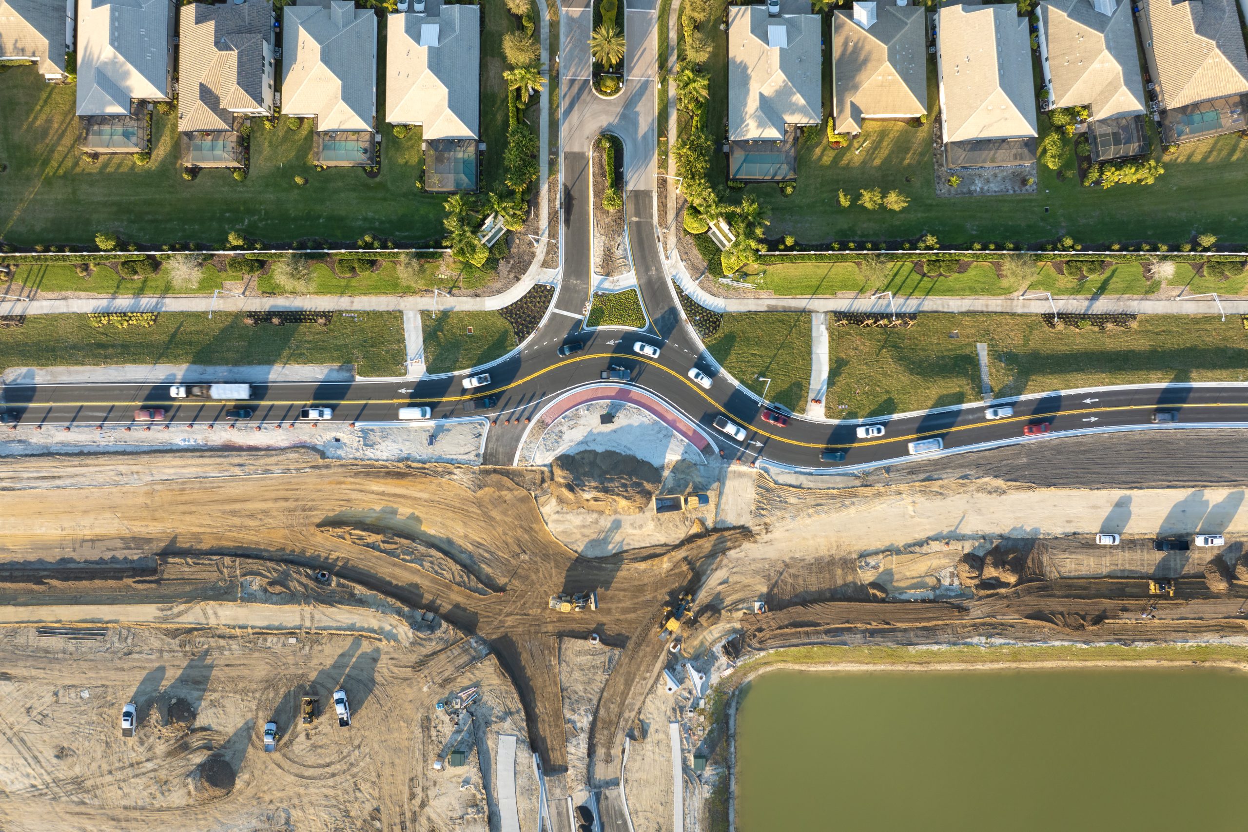 Aerial view of residential land development with road construction, infrastructure installation, and builder-ready lots in an Edmonton community.